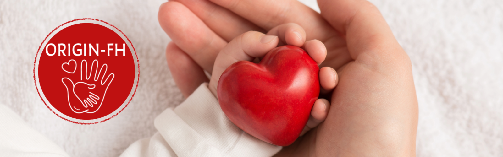 baby's hand holding a red heart with an adult hand cradling it